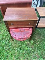 Front view showing upper drawer and open red swivel lower drawer