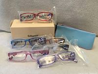 Six individually wrapped eyeglasses, GAOYE box, blue case visible