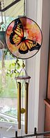 Full view showing glass butterfly panel and attached chime