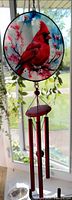 Full view of cardinal glass disc and hanging chime assembly