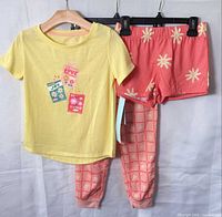 Front view of full 3-piece pajama set on hangers
