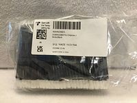 Front of sealed package showing black handles, white tips, and product label