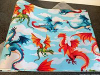 Full view of desk mat showing dragon pattern and sky background