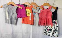 All six garments hanging side-by-side