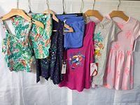 All six garments on hangers front view