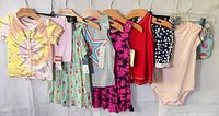 All eight clothing items displayed on hangers