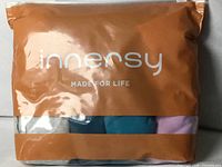 Sealed Innersy retail bag containing four folded briefs in assorted colours
