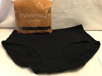 Front of one black brief with Innersy package