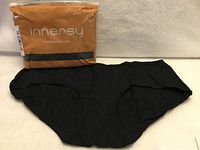 Front of sealed Innersy package with one black brief displayed
