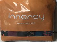 Front of sealed Innersy 6-pack showing branding and partial view of colours