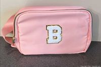 Front view showing pink bag and white B patch