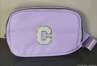 Front view showing purple bag and chenille letter C