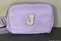 Front view showing purple fanny pack and J patch