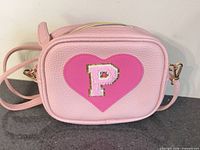 Front view showing heart appliqué with letter P and overall bag design