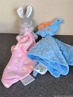 Both plush security blankets standing upright for full view