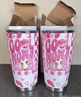 Front view of both tumblers with boxes showing Cool Moms Club graphic