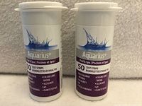 Front view of two sealed Aquarius Pool & Spa test strip canisters
