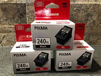 Front view of sealed Canon PG-240XL ink cartridge boxes