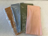 Front view of four faux leather eyeglass cases in assorted colors