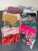 group of packaged baby bow headbands, assorted colours