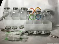 Full set showing bottles, lids, straws, cleaning tools, stickers