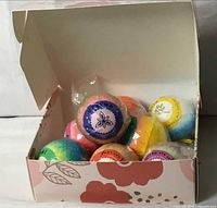 Open box showing multiple colorful bath bombs