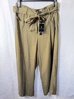 Front view of army green wide-leg capri pants showing paperbag waist and belt