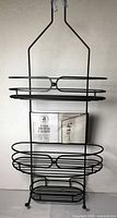 Full view of matte black steel 3-tier shower caddy hanging upright