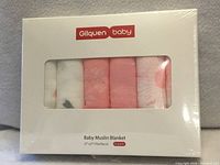 Front of sealed retail package showing six folded muslin blankets and product details