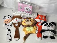Full view of five plush animal cat toys with original Nobleza packaging