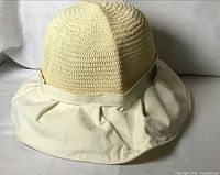 Front view of cream sun hat showing crocheted crown and fabric brim