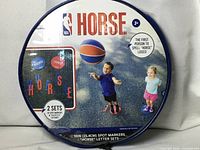 Front of sealed round carry bag showing NBA HORSE branding and contents image