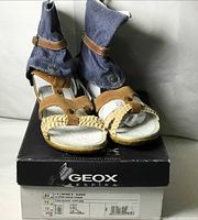 Front view of sandal pair on box