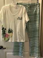 Front view of top and pants on hangers