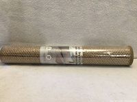Rolled beige braided bath mat in shrink wrap showing texture and label