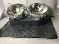 Complete set showing stand on mat with wrapped bowls in place