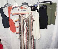 Full group of seven garments on hangers