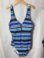 Front view of blue striped one-piece swimsuit on hanger