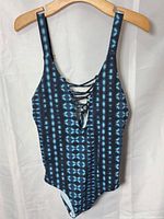 Front view blue tie-dye one-piece swimsuit with lace-up V-neck