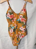 Front view of floral one-piece swimsuit showing pattern, neckline and straps