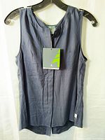 Front view of navy sleeveless blouse on hanger with tag