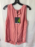 Front view of Woods pink sleeveless tank top with tag attached