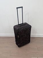Front view of dark floral Jetstream rolling suitcase showing telescopic handle extended and overall design