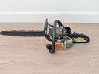 Full view of Stihl chainsaw showing bar, chain and body