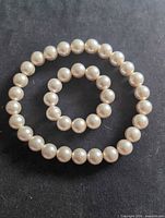 Necklace and bracelet laid flat to show full form and bead color