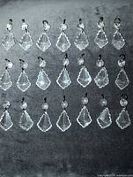 Twenty-four prisms laid out in rows showing uniform size and shape