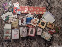 Entire lot laid out showing boxed cards, loose cards, envelopes, sticker sheets and gift wrap