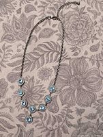 Full view of entire necklace laid flat showing design and length