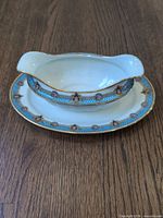 Full view of gravy boat attached to underplate showing decoration