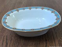Top view of oval serving bowl showing interior, border pattern and gilt rim
